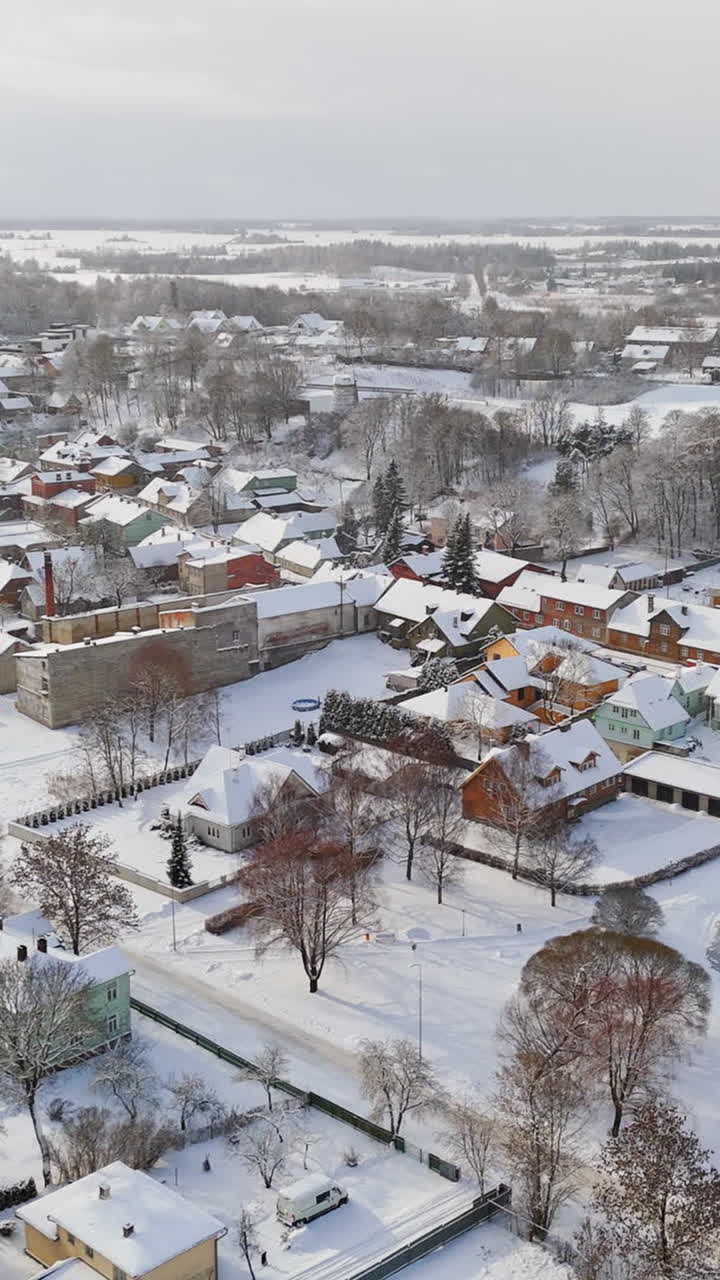 Vertical drone shot over snowy homes in the neighborhoods of Rakvere, Estonia
