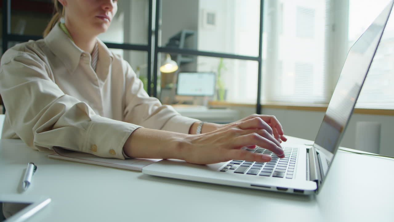 Businesswoman Working on Laptop at Office Desk