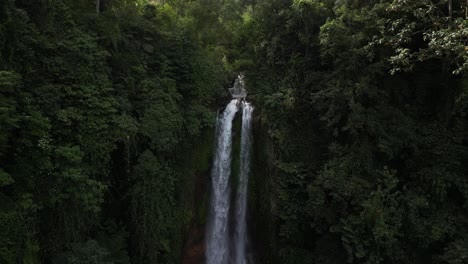 close up to a wide view of gitgit waterfall in the north of bali, indonesia