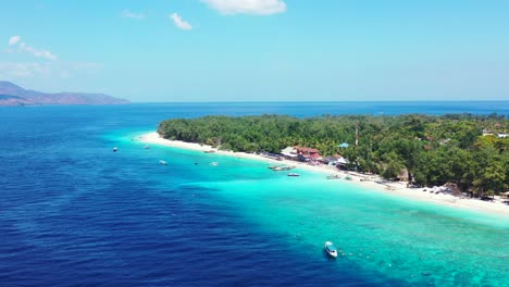 Beautiful-island-getaway-with-bright-blue-waters,-white-sand,-and-gorgeous-greenery