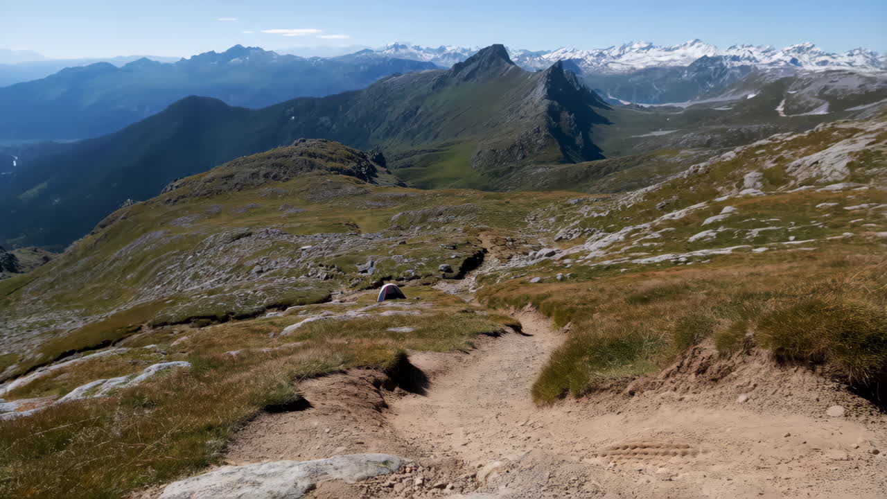 Hiker with Backpack and Trekking Poles on a Scenic Mountain Trail