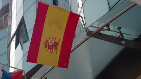 spanish flag hanging from a modern building