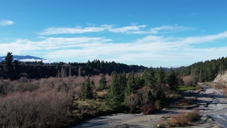 Aerial-reverse-across-river-showing-vegetation-types-on-valley-floor---Kowai-River,-Canterbury