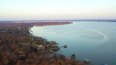 aerial drone view of lake of the ozarks reservoir in midwest missouri with vacation lake houses and floating docks on the calm water