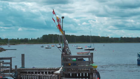 fishing pier with fishing flags on top, sea in the background