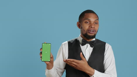 hotel worker bellhop points at phone with isolated mockup display