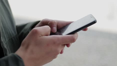 cropped shot of woman using cell phone outdoor