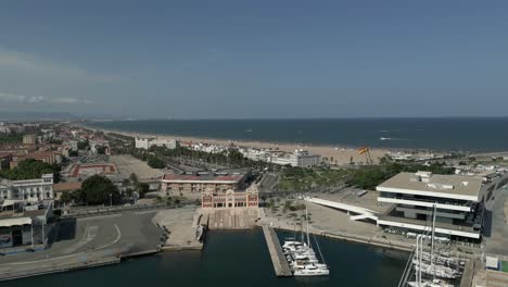 revealing aerial view of la marina de valencia summer beach and mediterranean sea, spain