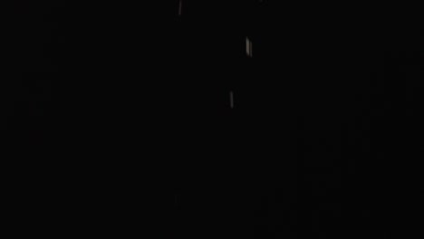 cookie crumbles falling in slow motion, black background