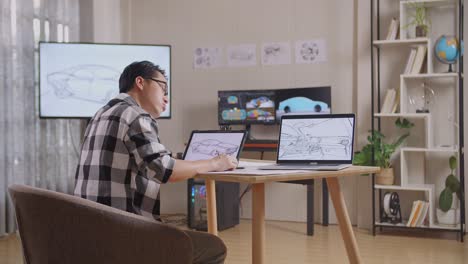 side view of asian male having a headache while drawing new car design concept on a tablet in the studio with tv and computers display 3d electric car model