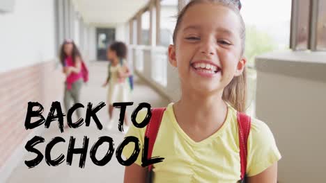animation of back to school text over smiling biracial schoolgirl in school corridor