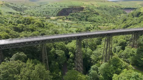 Aerial-profile-of-Meldon-Viaduct-with-Okement-Valley-as-a-scenic-backdrop-in-Dartmoor-National-Park