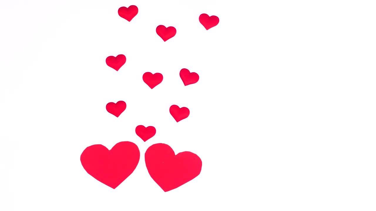 Two hearts fall in love and little hearts come from them. Stop motion valentine's day