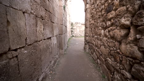 Walking-Through-Narrow-Path-With-Ancient-Stone-Walls-From-Sides
