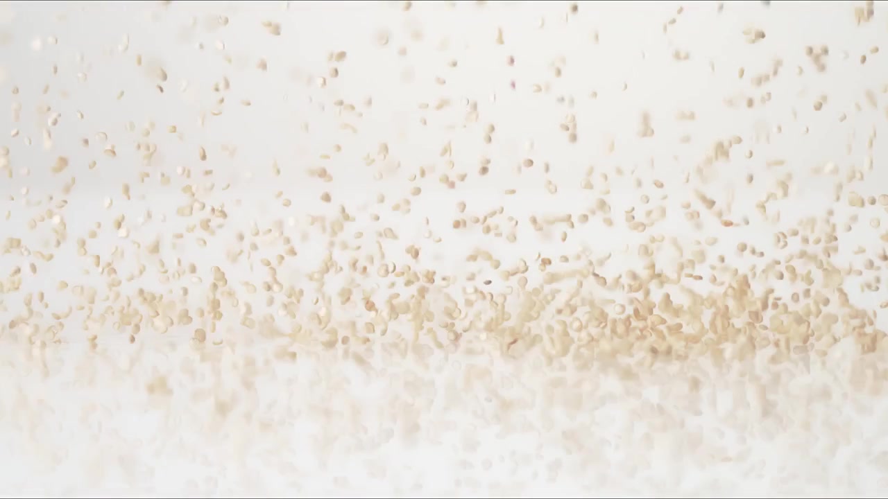 Plant protein superfood Quinoa bouncing on a white tabletop in slow motion close up macro before settling.