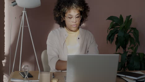 young woman working on laptop at home