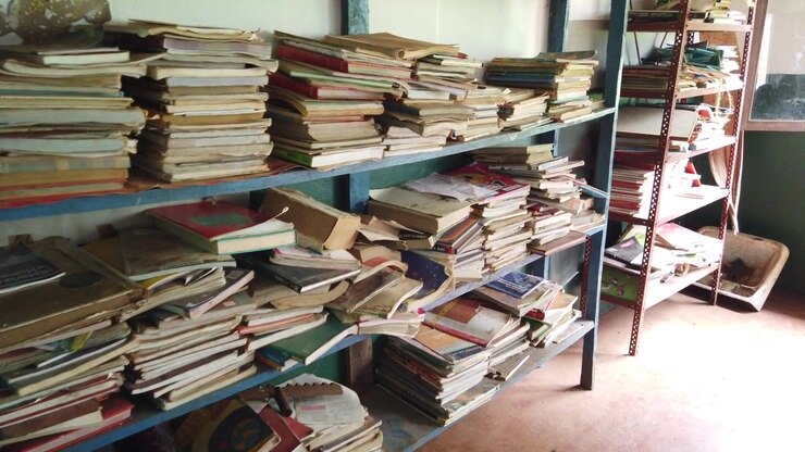 Walking POV of Old Stacked Books on Shelves Inside a Classroom of a Rural School