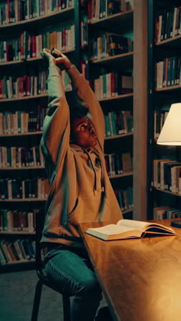 student stretching in library