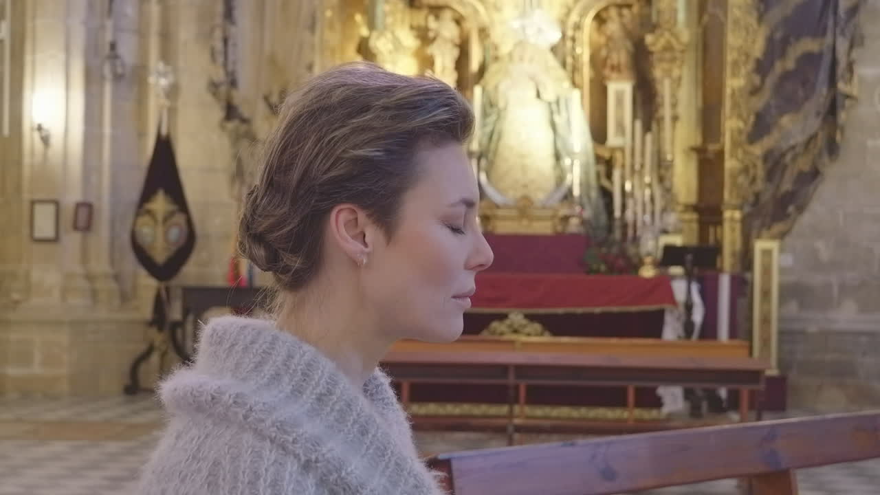 Close Up Profile View of Pretty Woman Praying in Catholic Church
