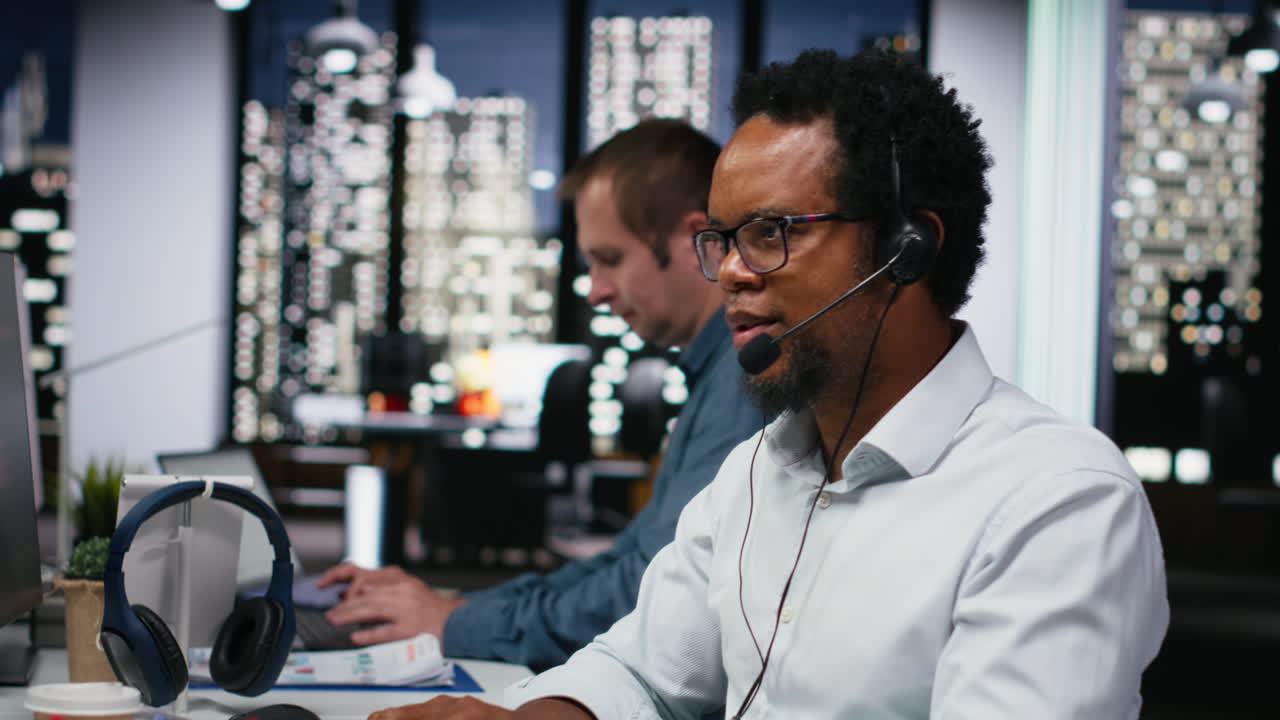African American Man Working in Call Center at Night