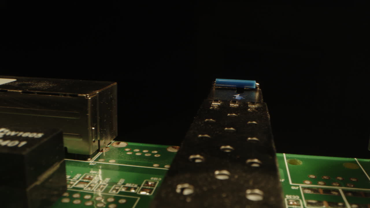 Extreme close dolly of components on a circuit board against a black background