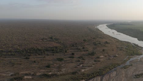 slow descent onto the crocodile river in south africa’s kruger park early morning, aerial push-in