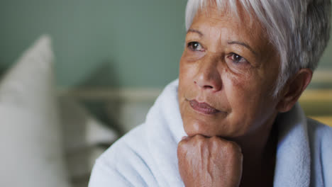 Close-up-of-senior-mixed-race-woman-at-home-in-thought