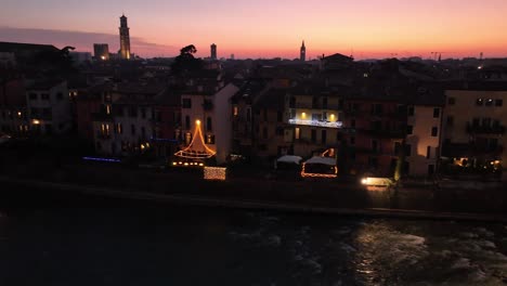 Aerial-Panning-Drone-Shot-of-Verona-Skyline-at-Night-with-Sunset,-close-to-Ponte-Pietra