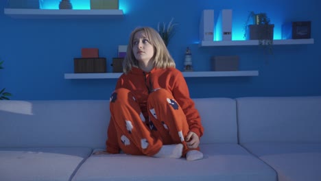 scared woman at home alone at night. psychological problems.