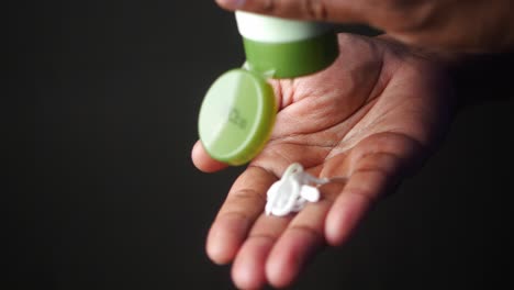 close up of a person's hand applying hand cream.