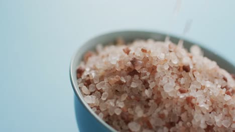 video of himalayan salt in a bowl on blue background