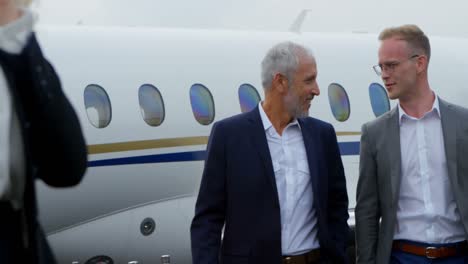 businessmen interacting with each other at terminal 4k