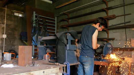 metalsmith using machine in factory 4k