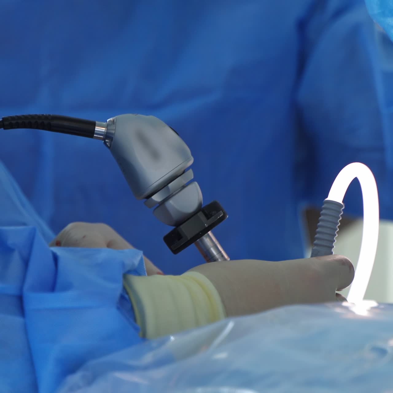 Doctor uses medical instrument during operation. Special equipment in surgeon's hands in clinic. Modern medicine. Close-up