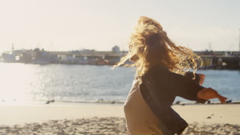 woman standing with arms out stretched at dock 4k