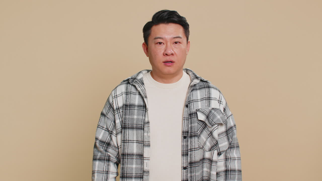 Strict asian man warning hands gesture saying no be careful advice to avoid danger caution