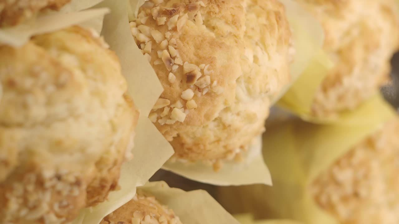 Close-up of freshly baked nut muffins in paper liners