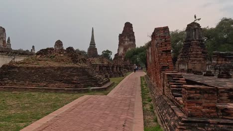 explore the weathered brick structures and pathways of ancient temple ruins surrounded by lush greenery.
