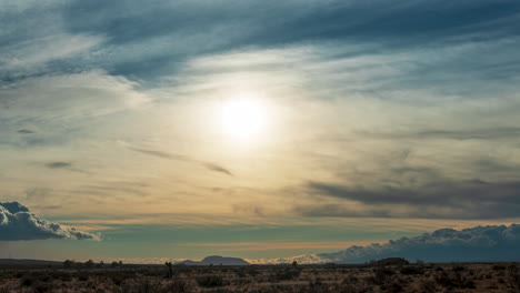 sunset over the mojave desert wasteland displays vibrant colors in the long duration time lapse