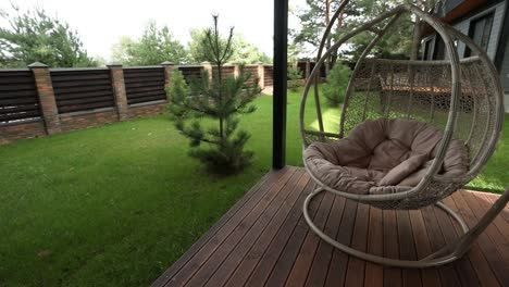 cozy outdoor swing chair on a wooden porch