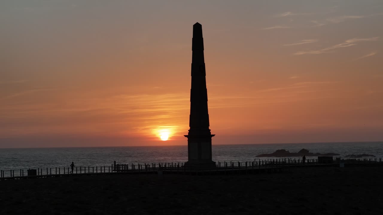 People enjoying the sunset on the boardwalk at Memoria beach