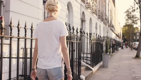 beautiful blonde walking through city