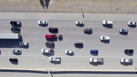 top down aerial view of cars moving slowly on a highway on a bright sunny day