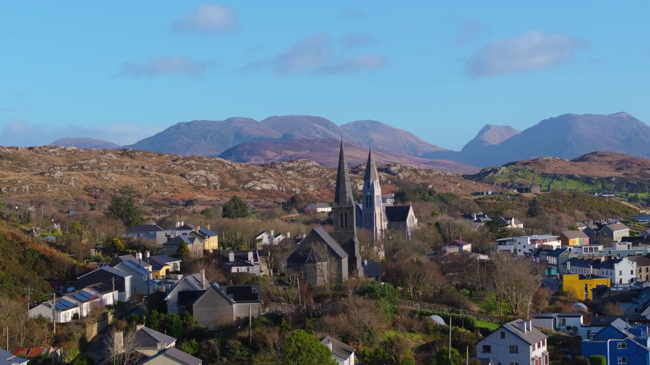 4K Aerial drone footage of St Joseph’s Church and Christ Church Clifden with Connemara Mountains Background_012