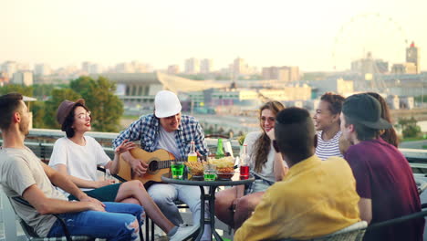 friends enjoying a rooftop party at sunset