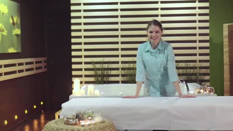 smiling spa therapist in modern relaxation area