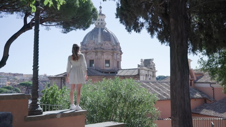 Young Girl Exploring The City Of Rome, Italy With A View Of The Dome Of Santa Luca e Martina