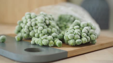 frozen peas on a cutting board