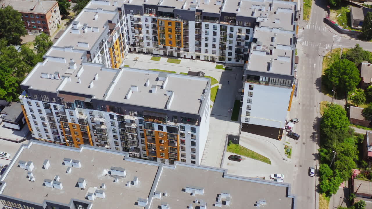 Contemporary apartments in the city complex. Modern residential area with multi-storey buildings. New tall housing apartments. Aerial view.