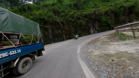 adventure ride of scooter through mountain road at ha giang loop on a cloudy day in vietnam. pov shot